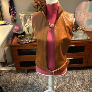 Buttery leather moto vest with attached belt detail and high collar.